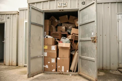 Box de stockage abandonné ouvert lors d'une vente aux enchères en France, rempli de cartons et de meubles entassés